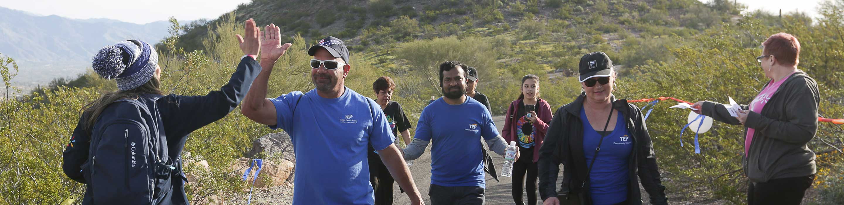 volunteerism-banner TEP employees working and participating in charity walk