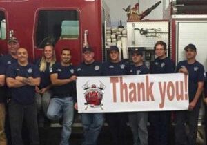 Firefighters in front of truck